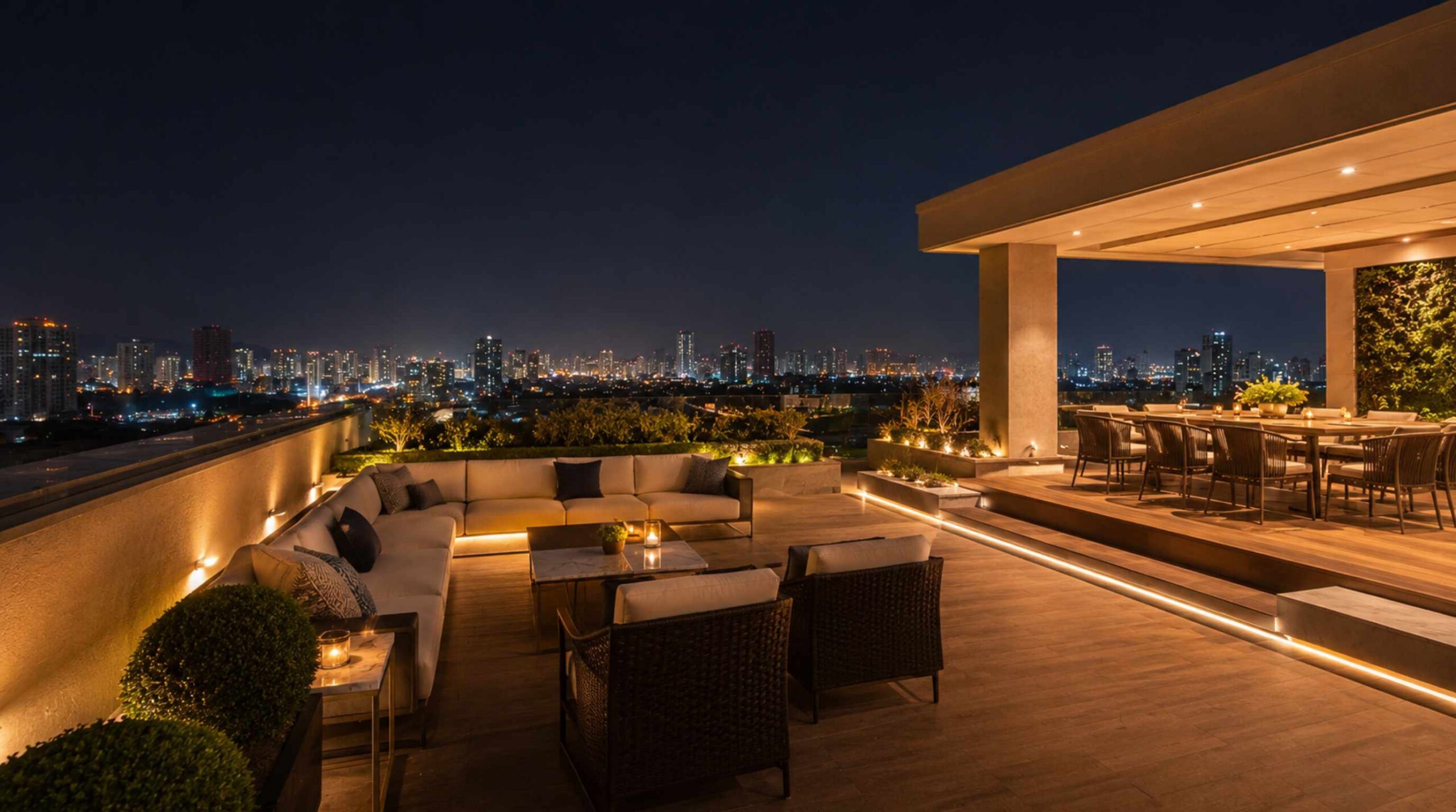 Luxury rooftop terrace with hidden outdoor audio system overlooking the Kharghar and Navi Mumbai skyline at night.